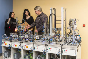 Electro-Mechanical students in lab with Professor