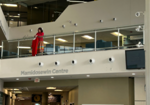 Anita tenasco hangs dresses in the E Building