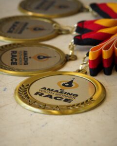 Amazing Youth Worker Race medals on a table.
