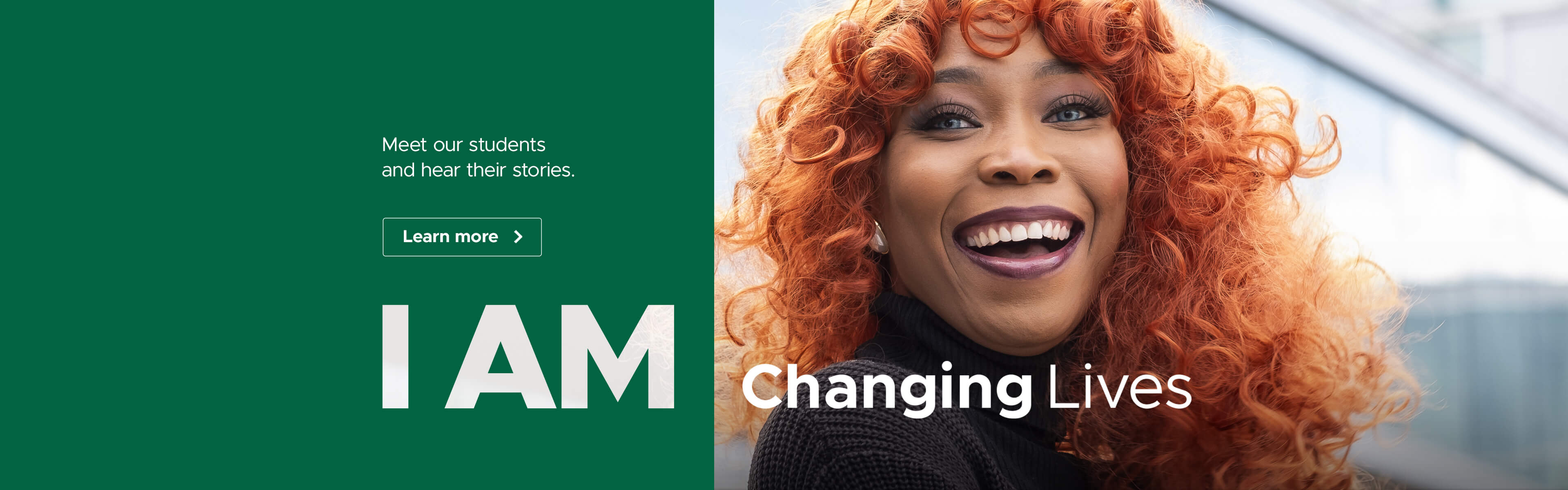 A close-up of a person with vibrant red hair smiling warmly at the camera. They are wearing a black top, and the focus is on their joyful expression and striking hair colour.